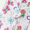 Children's outfit with colorful butterfly and flower patterns on a white background