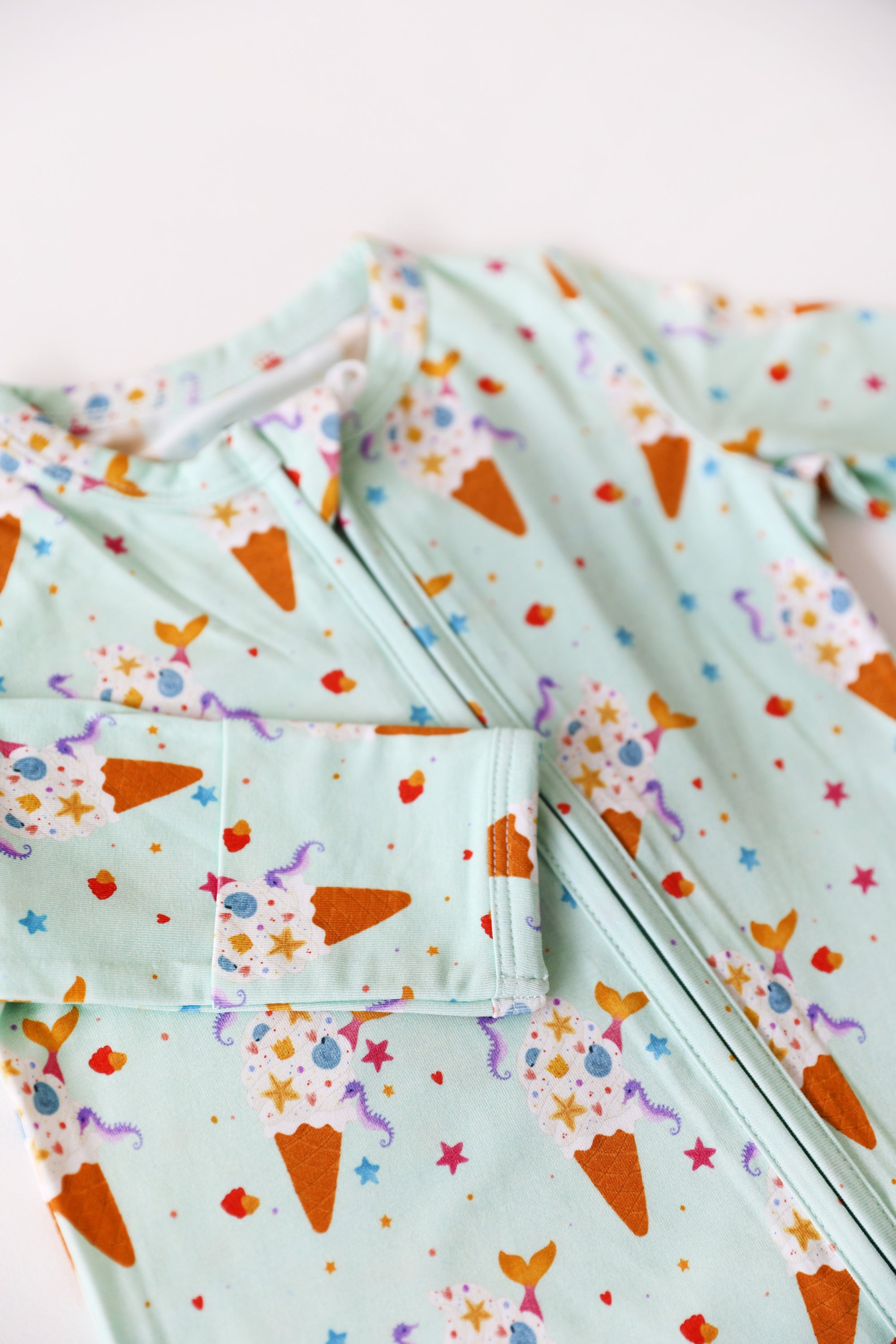 Light blue fabric with colorful carrot pattern on a white background