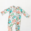 Baby onesie with dinosaur pattern on a white background