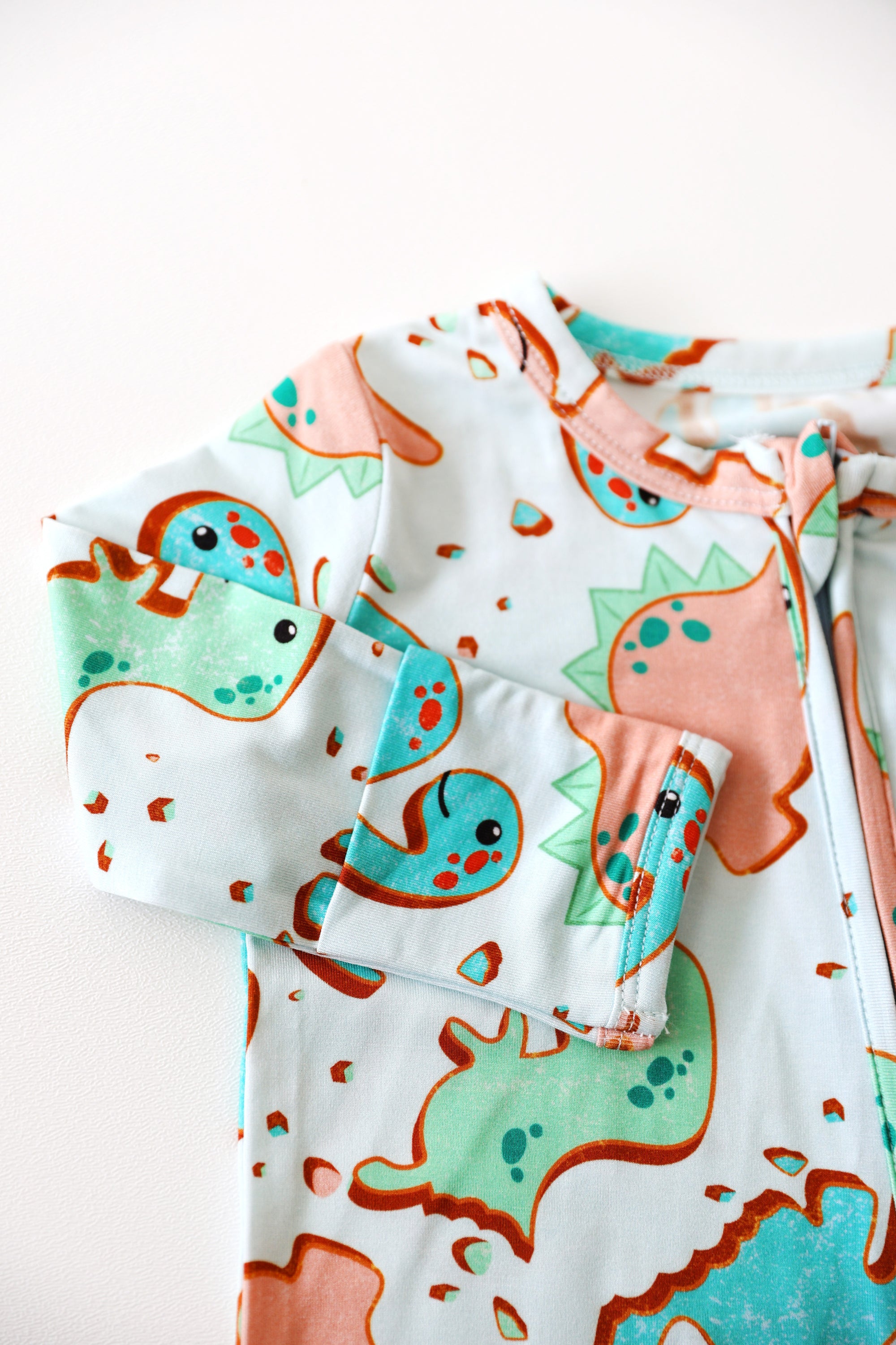 Children's outfit with dinosaur pattern on a white background