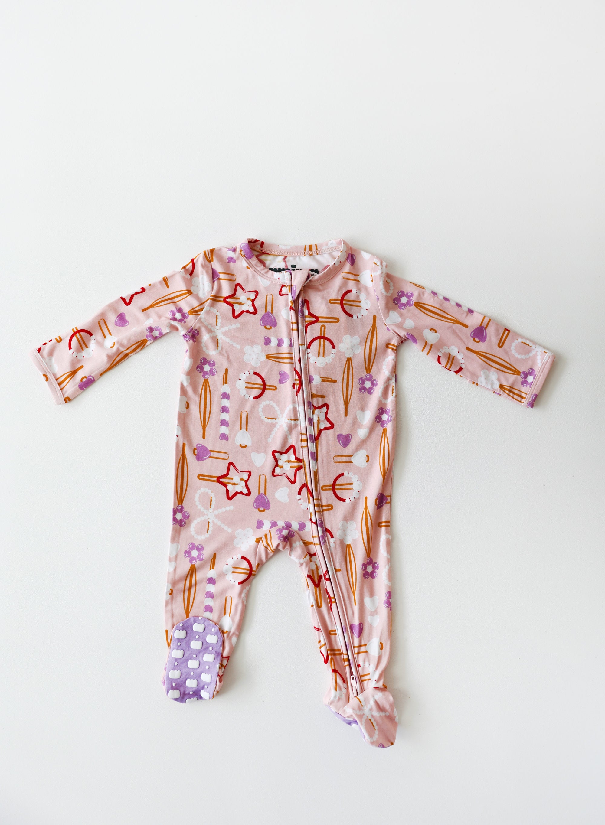 Baby onesie with colorful patterns on a white background